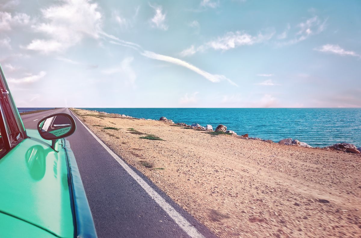 Semi-truck driving on a scenic highway